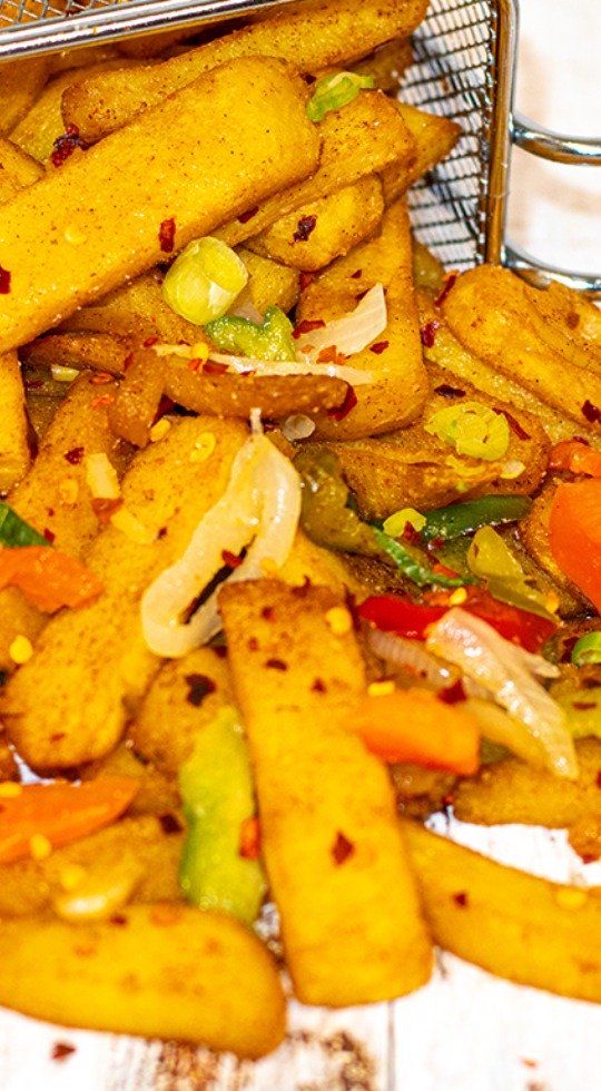 Zesty Salt 'n Pepper Fries: A Huddersfield Delight Salt and pepper chips falling out of a basket